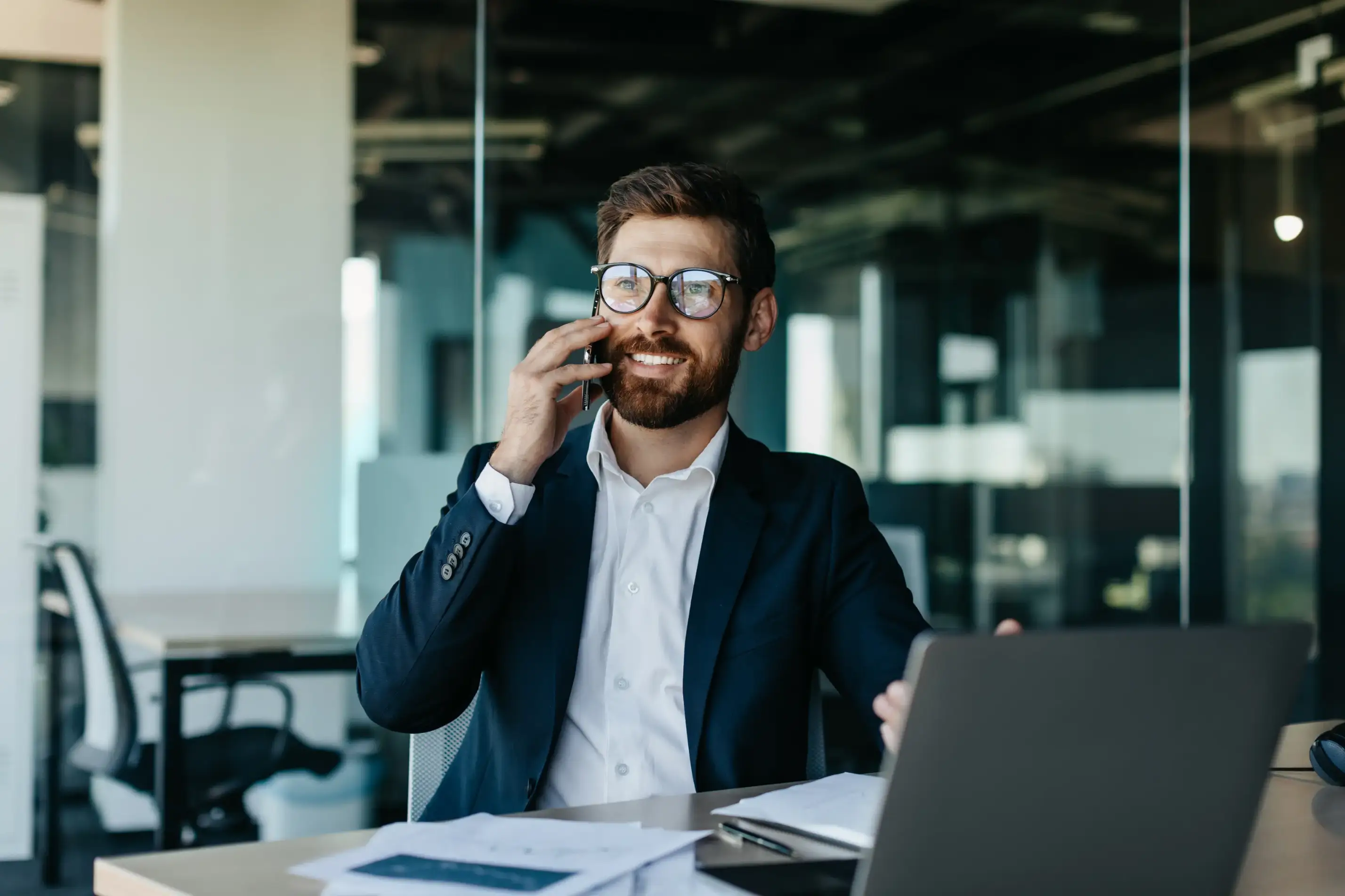 Business owner on phone dealing with legal compliance issues and consequences of not having registered agent for company requirements.