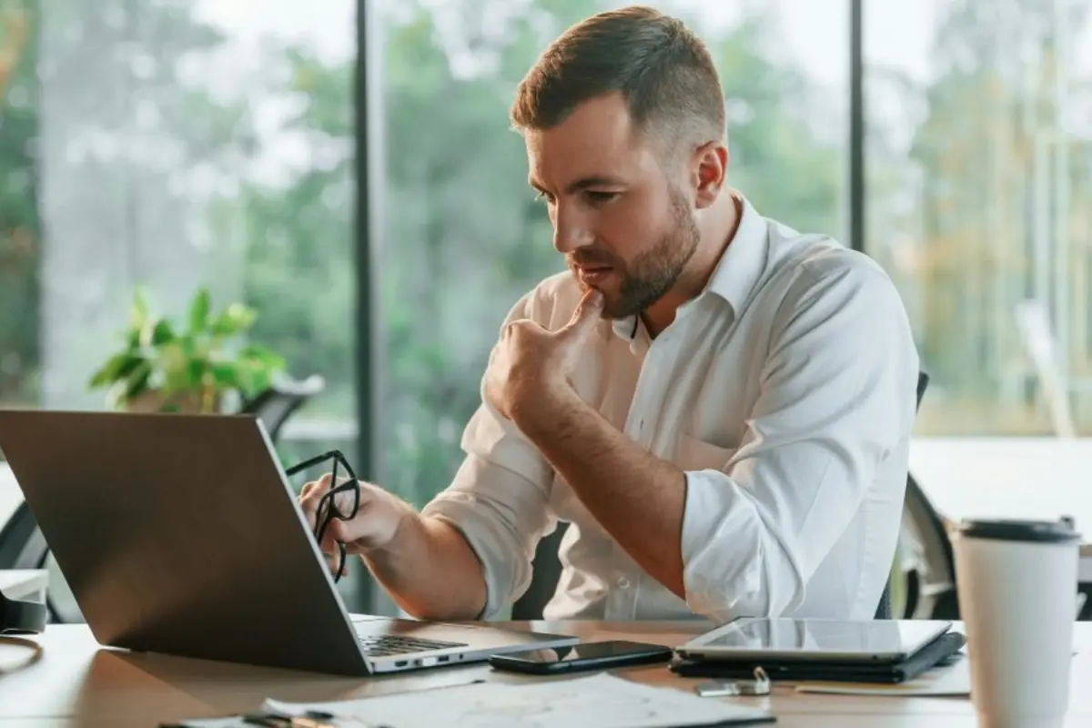 Business professional reviewing compliance information on a laptop, representing InCorp’s business formation and compliance services.